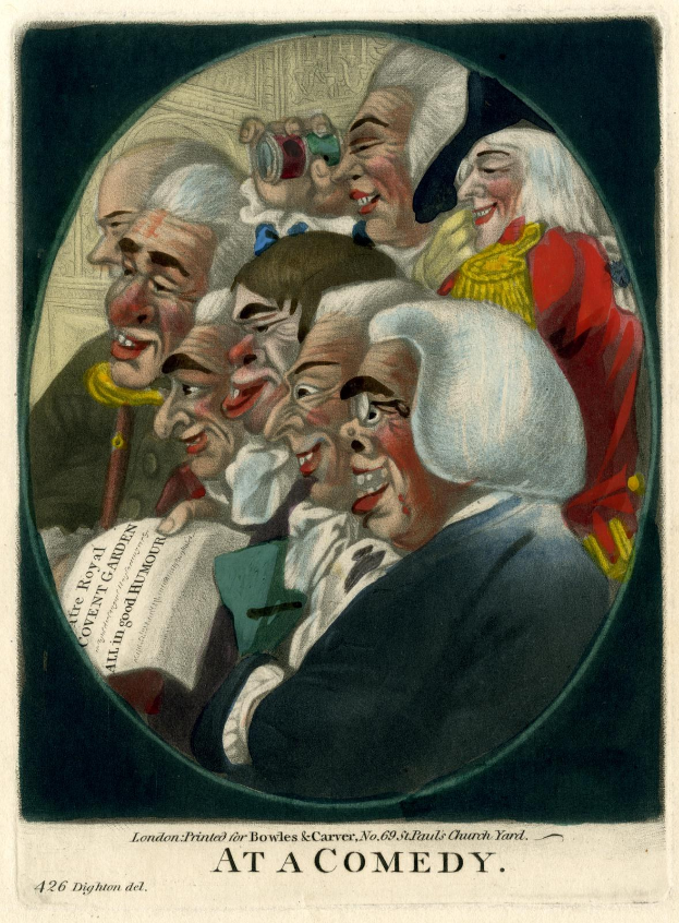 Eine Gruppe von Menschen, die in einem Kreis stehen, einer hält ein Blatt Papier in der Hand und lacht und amüsiert sich auf einem Comedy-Event.